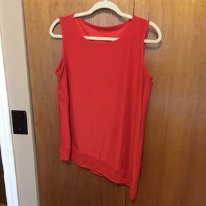 Red asymmetrical tank with sheer panel at hem